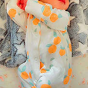 Nysha is registered to the contest to win money with this photo: newborn, baby, sleeping, onesie, orange_pattern, blanket, star_pattern, infant, cute, soft_texture, peaceful, hands, face, lying_down, cozy, child, bed, resting, clothing, portrait