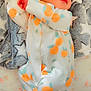newborn, baby, sleeping, onesie, orange_pattern, blanket, star_pattern, infant, cute, soft_texture, peaceful, hands, face, lying_down, cozy, child, bed, resting, clothing, portrait
