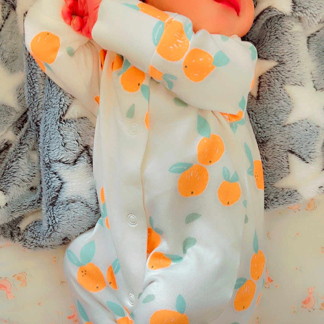 Nysha is registered to the contest to win money with this photo: baby, bed, blanket, child, clothing, cozy, cute, face, hands, infant, lying_down, newborn, onesie, orange_pattern, peaceful, portrait, resting, sleeping, soft_texture, star_pattern