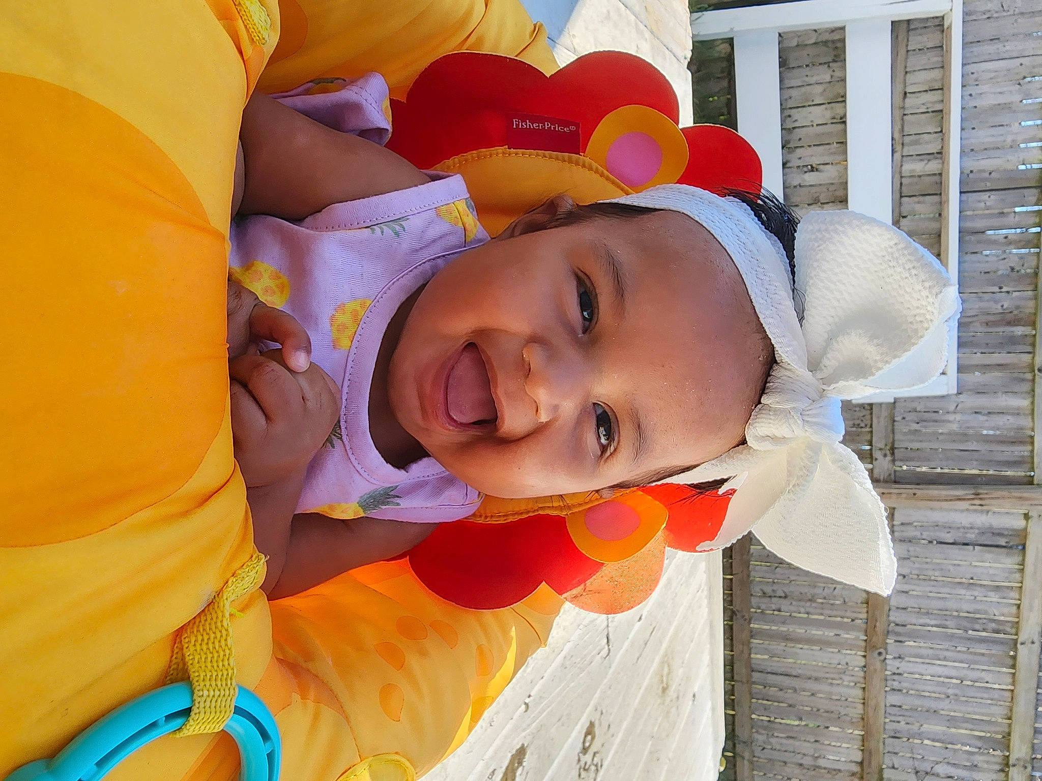 Neliah is registered to the contest to win money with this photo: baby, baby_toddler_clothing, child, happy, hat, headgear, human_body, leisure, nose, orange, people_in_nature, person, plant, recreation, smile, sun_hat, toddler, tree, window, wood