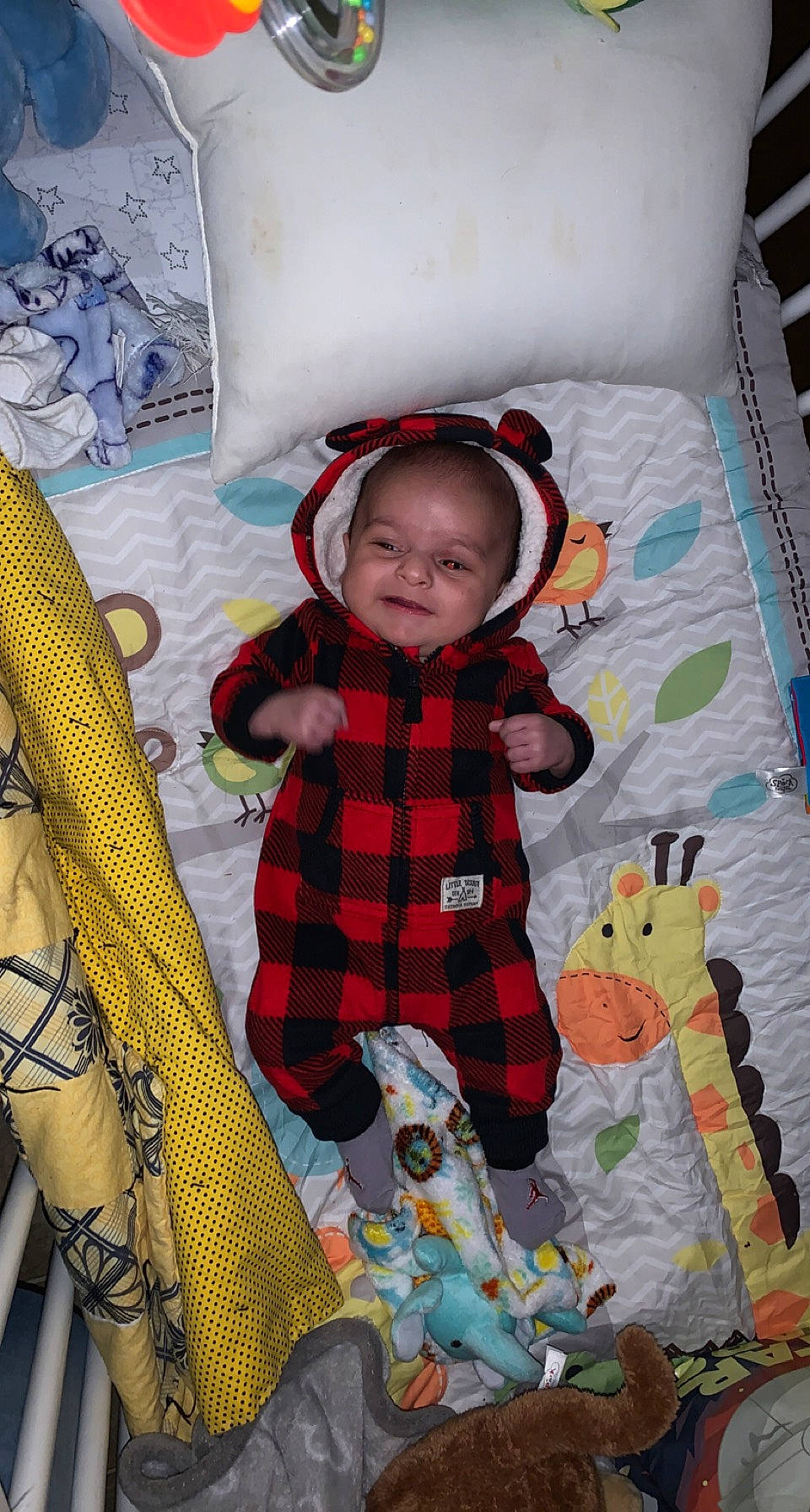 Tyson is registered to the contest to win money with this photo: baby, baby_products, baby_toddler_clothing, child, comfort, fun, happy, linens, pattern, people, person, plaid, product, room, sitting, sleeve, textile, toddler, toy, white