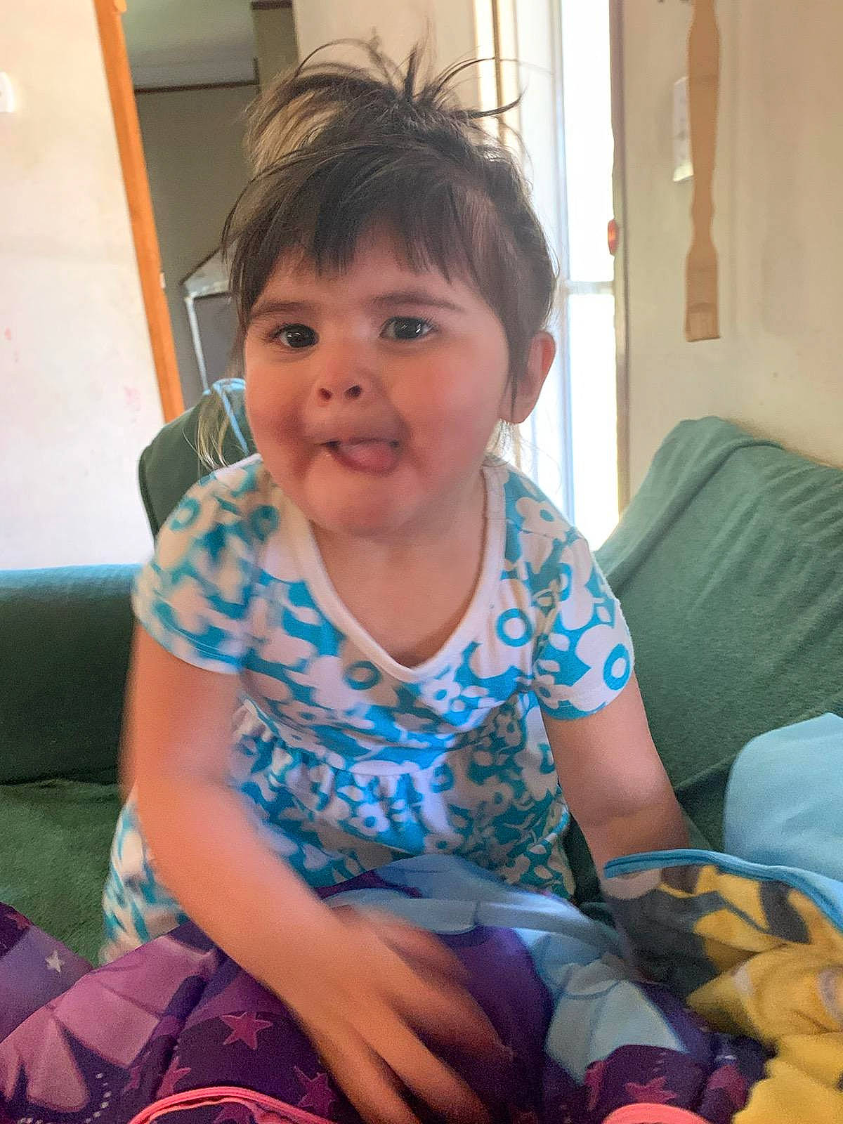 Adaline is registered to the contest to win money with this photo: child, electronic_device, face, person, sitting, skin, smile, toddler, vacation