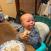 Kinsley is registered to the contest to win money with this photo: toddler, child, high_chair, messy_face, food, sandwich, plate, kitchen, table, chair, indoor, meal, clothing, curious, expression, hands, blush, face, baby, seat