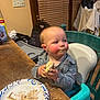 toddler, child, high_chair, messy_face, food, sandwich, plate, kitchen, table, chair, indoor, meal, clothing, curious, expression, hands, blush, face, baby, seat