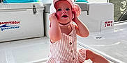 Kinsley joined the competition — help win amazing prizes! toddler, child, boat, deck, sun_hat, pink_stripes, smiling, sitting, vacation, water, sky, clouds, marine_equipment, outdoor, summer, cute, happy, playful, legs, barefoot