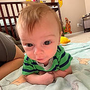 Oliver is registered to the contest to win money with this photo: baby, infant, child, nursery, crib, blanket, plush_toy, winnie_the_pooh, tigger, mobile, wall_decal, carpet, onesie, striped_shirt, closeup, portrait, eyes, hair, person, curious_expression