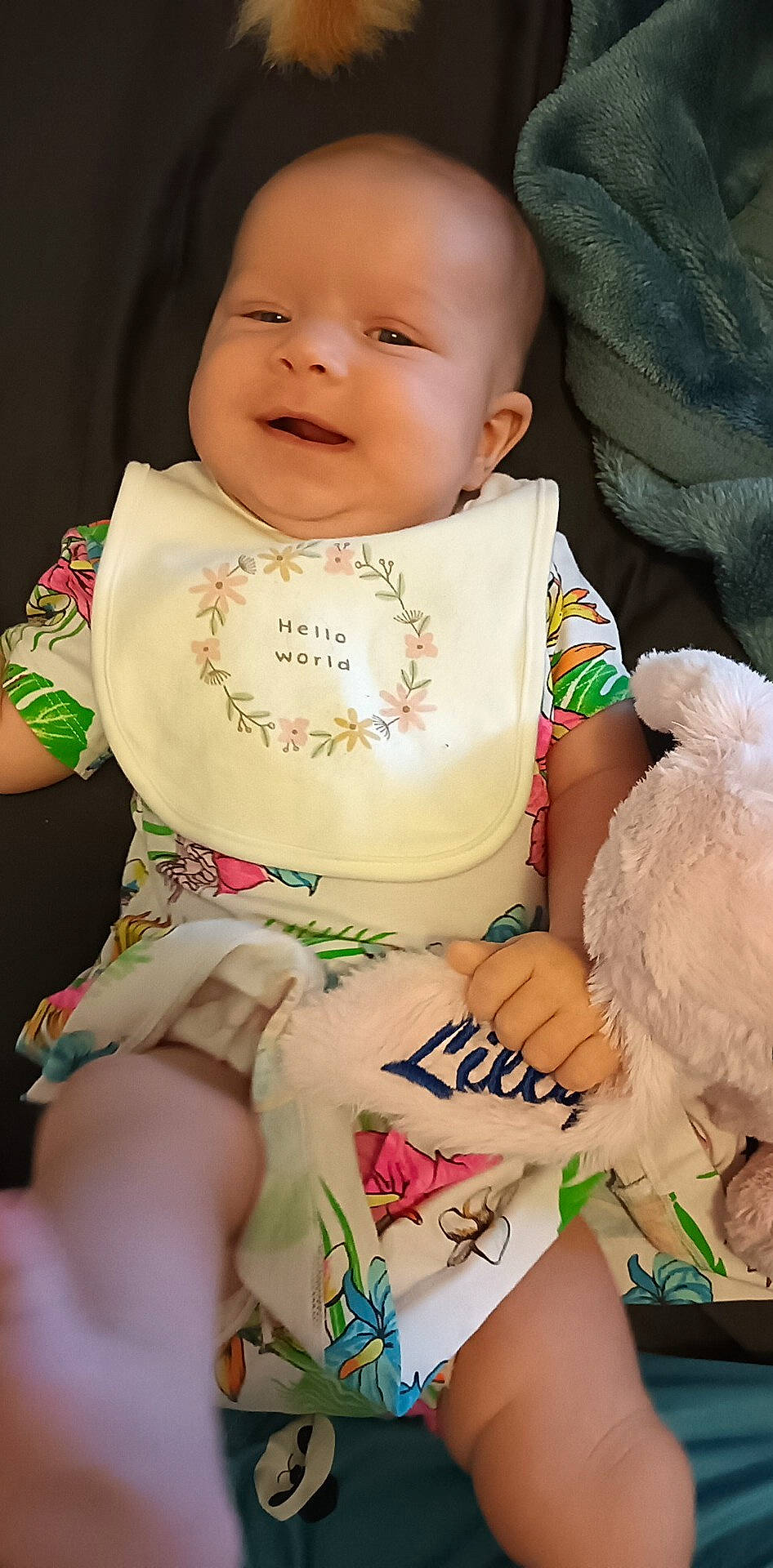 Lilly is registered to the contest to win money with this photo: baby, baby_toddler_clothing, cheek, child, eye, finger, green, happy, head, human_leg, nail, person, pink, sitting, skin, sleeve, smile, thigh, toddler, white