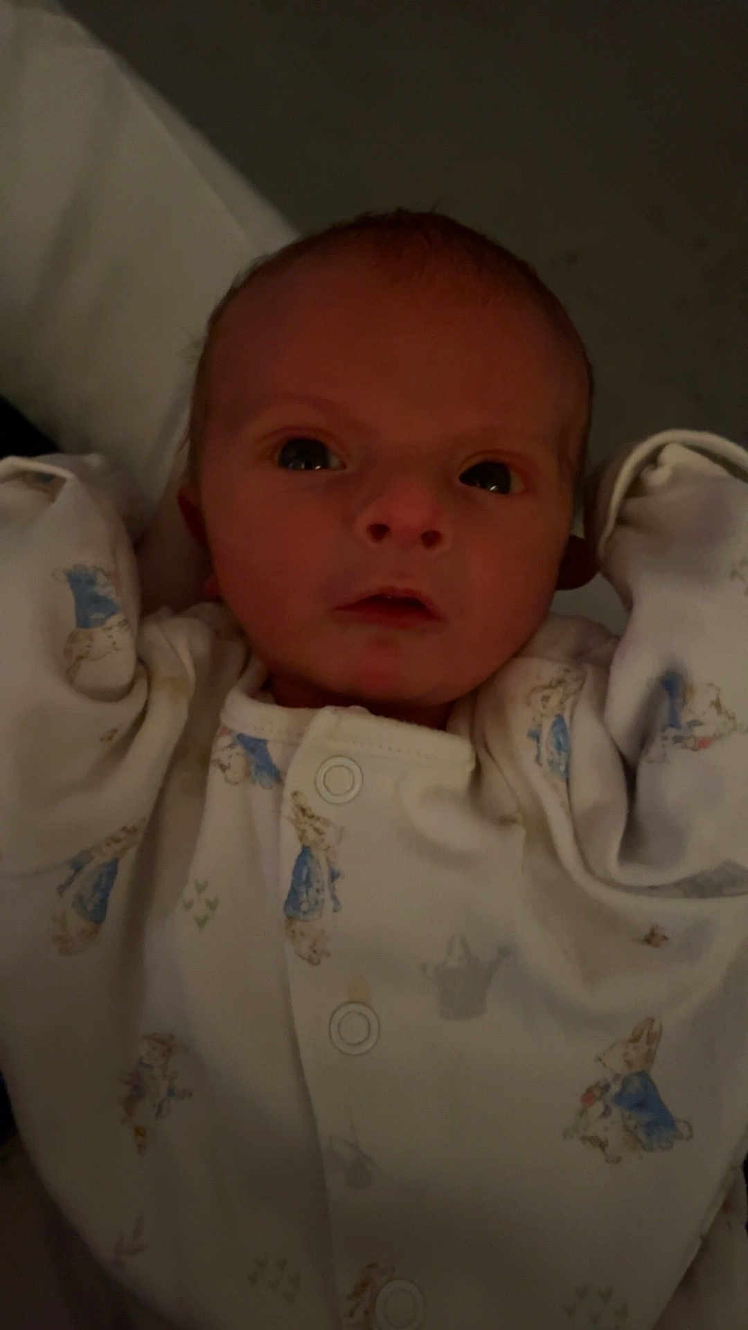 Noah is registered to the contest to win money with this photo: baby, newborn, infant, onesie, clothing, face, person, arms, sleepwear, cute, child, portrait, indoors, young, expression, looking, human, skin, head, eyes