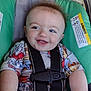 baby, smiling, car_seat, blue_eyes, child, clothing, straps, safety_harness, cute, infant, seat, happy, face, head, toddler, patterned_shirt, hair, skin, indoor, closeup