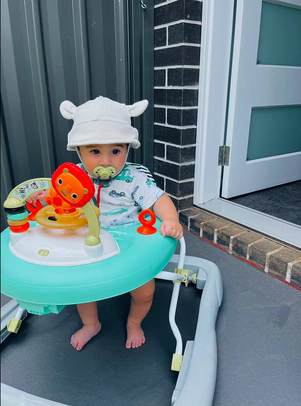 Jeziah is registered to the contest to win money with this photo: baby, baby_products, baby_toddler_clothing, chair, child, curtain, fun, hat, headwear, leisure, person, plate, play, recreation, room, sandal, sitting, sun_hat, table, tableware