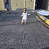 Harshavardhan is registered to the contest to win money with this photo: child, toddler, person, man, outdoor, pavement, clothing, traditional_attire, shadow, light, garage, door, building, casual, walking, smile, sidewalk, curb, asphalt, sunlight