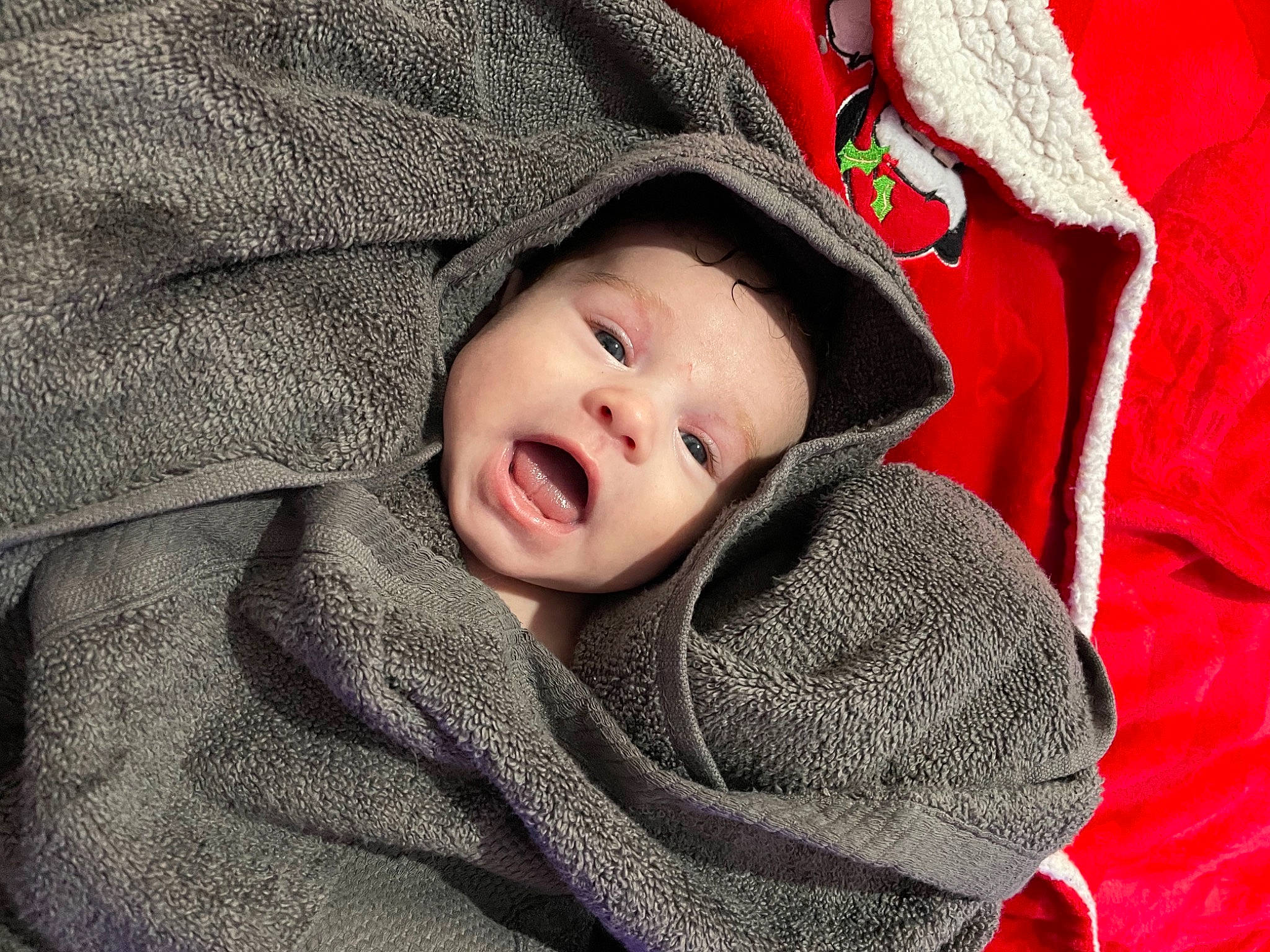 Antonia is registered to the contest to win money with this photo: baby, baby_toddler_clothing, carmine, cheek, comfort, eye, face, fashion_accessory, grass, grey, linens, lip, pattern, person, red, skin, sleeve, smile, toddler, winter