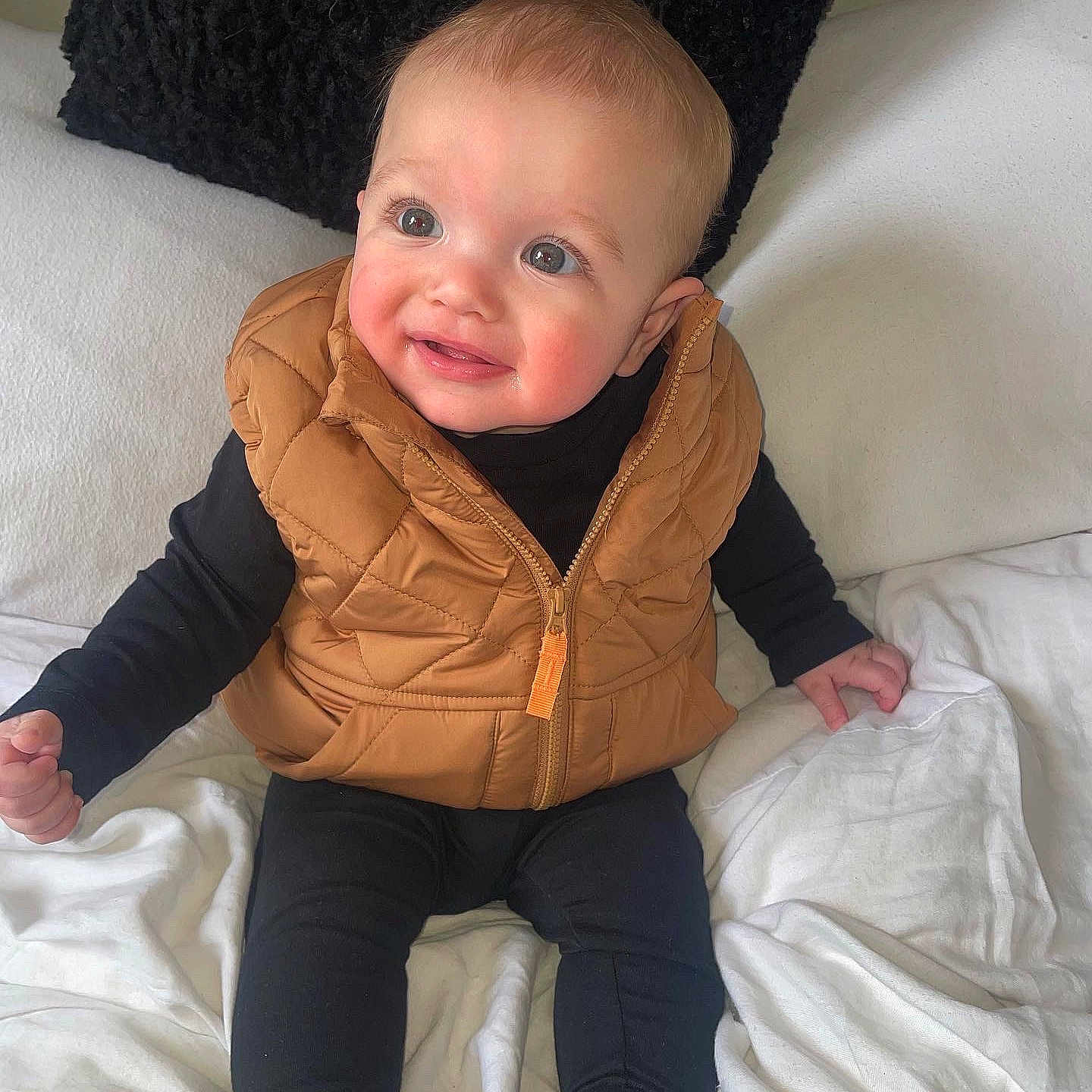 Luca-Jay joined the competition — help win amazing prizes! baby, babylaughing, blanket, clothing, coat, cushion, face, happy, head, homedecor, jacket, jeans, pants, person, photography, portrait, sitting, sleeve, smile, vest