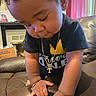 Tyreek is registered to the contest to win money with this photo: accessories, bodypart, box, boy, child, clothing, couch, face, finger, furniture, hand, head, jewelry, male, necklace, person, photography, portrait, sitting, t_shirt
