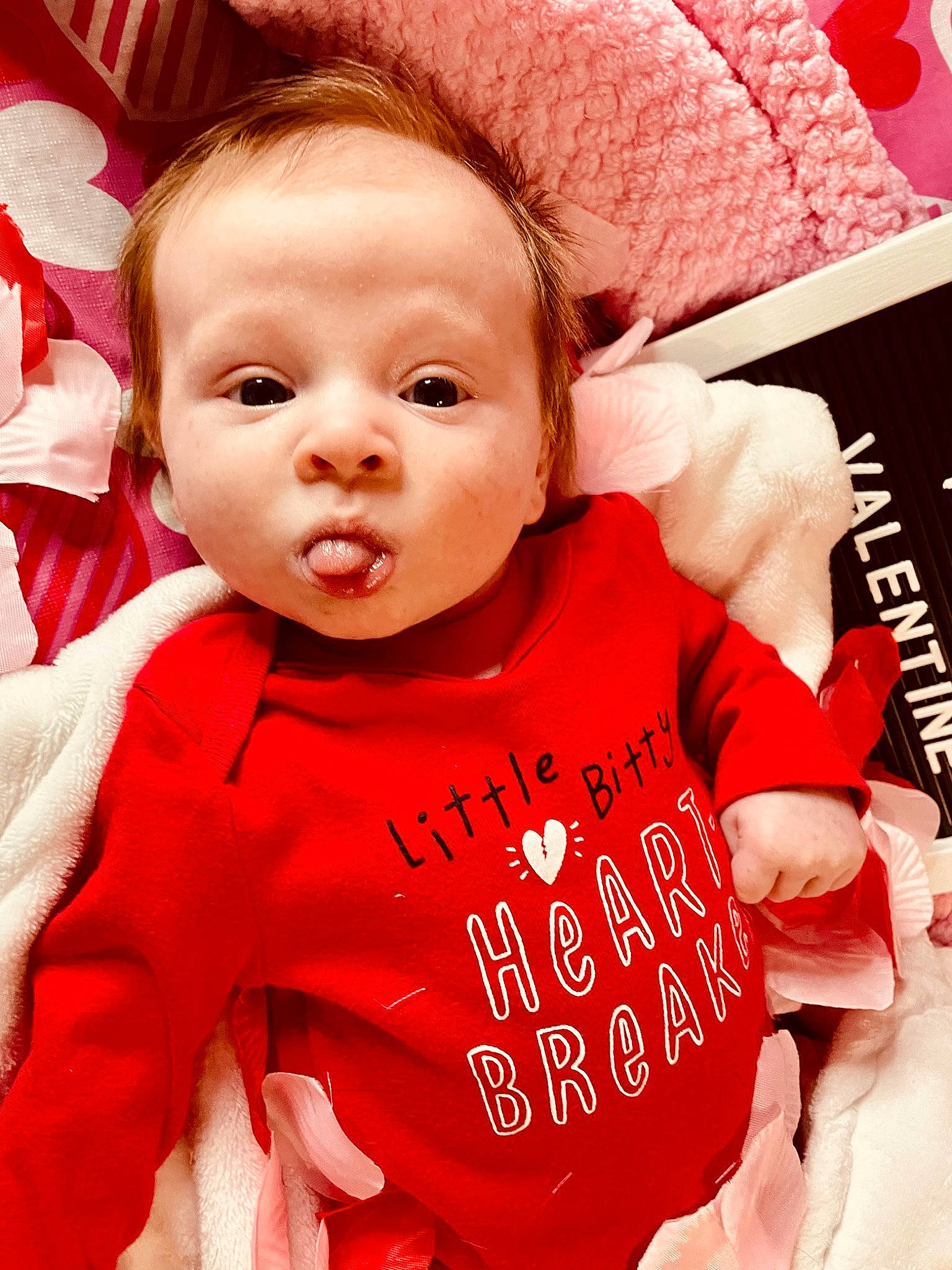 Alyvia is registered to the contest to win money with this photo: baby, baby_toddler_clothing, cheek, child, cool, facial_expression, fashion_accessory, font, happy, human, lip, outerwear, person, pink, product, red, skin, sleeve, t_shirt, textile