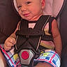 baby, infant, child, smiling, portrait, car_seat, seatbelt, harness, safe_travel, vehicle_interior, plaid_clothing, colorful_clothing, sitting, close_up, face, baby_carrier, happy, indoors, date_stamp, photograph
