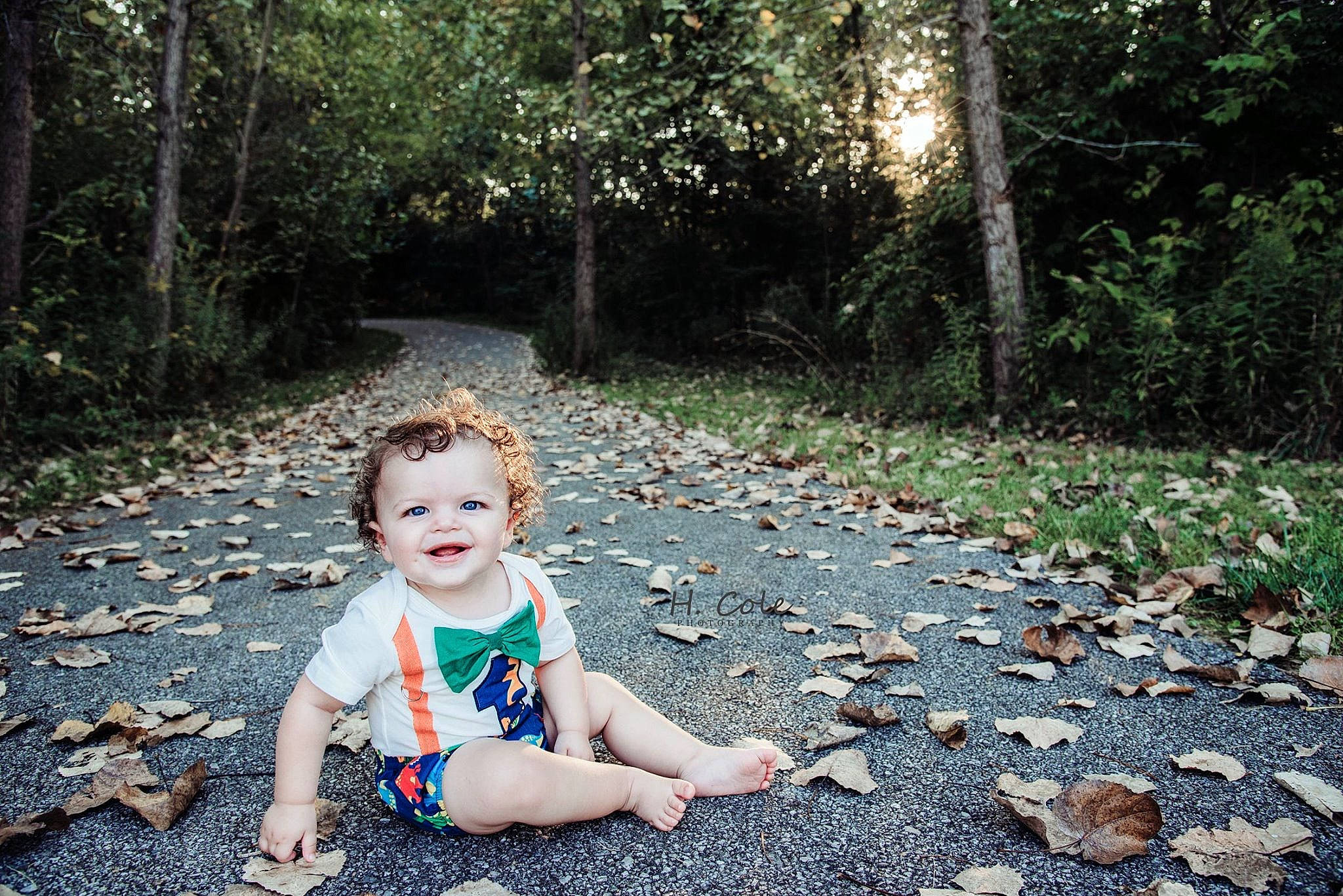 Josef is registered to the contest to win money with this photo: beauty, child, dress, forest, grass, green, joy, leaf, people, people_in_nature, person, photograph, photography, plant, rock, sitting, spring, summer, sunlight, toddler