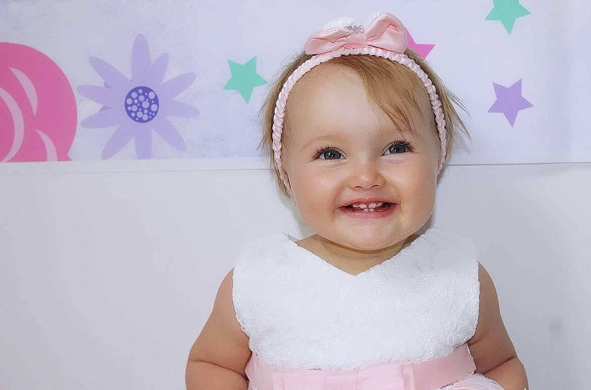 Lucia a rejoint le concours — aidez-le/la à gagner de superbes lots ! baby, baby_toddler_clothing, cheek, dress, eyelash, fun, hairstyle, happy, headgear, headpiece, joy, person, pink, product, purple, skin, sleeve, smile, textile, toddler