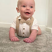 Asher joined the competition — help win amazing prizes! baby, child, crawling, carpet, bow_tie, suspenders, smiling, happy, indoors, cute, portrait, infant, clothing, person, face, hands, head, eyes, mouth, skin