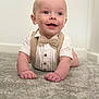 baby, child, crawling, carpet, bow_tie, suspenders, smiling, happy, indoors, cute, portrait, infant, clothing, person, face, hands, head, eyes, mouth, skin