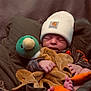 newborn, baby, infant, hat, beanie, plush_toy, duck, blanket, basket, sleeping, cozy, cute, soft, hands, feet, clothing, portrait, indoor, warm_lighting, toddler