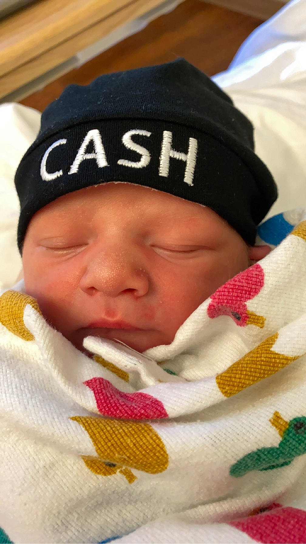 Cash is registered to the contest to win money with this photo: baby, baby_sleeping, cap, cheek, chin, comfort, eyebrow, eyelash, finger, hand, headgear, headwear, knit_cap, linens, lip, mouth, nose, person, product, skin