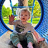 Stellar is registered to the contest to win money with this photo: toddler, child, playground, blue_tunnel, slide, greenery, park, outdoor, waving, messy_hair, casual_clothing, barefoot, person, daylight, happy, curious, sitting, adult, shoe, metal_surface