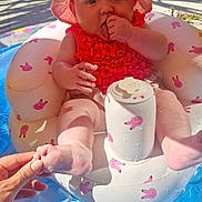 Ayra joined the competition — help win amazing prizes! baby, infant, pool, inflatable, float, pink_hat, red_swimsuit, sunlight, grass, hand, water, summer, cute, outdoor, playful, child, sitting, foot, thumb, bunny_pattern