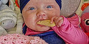 Ayra joined the competition — help win amazing prizes! baby, infant, blue_eyes, headband, pink_clothing, blanket, biscuit, plush_toy, stroller, cushion, indoor, child, cute, hand, face, portrait, soft_toys, cozy, smiling, comfort