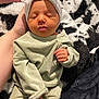 baby, newborn, infant, headband, bow, sleeping, hand, blanket, clothing, soft_texture, peaceful, cute, cozy, person, portrait, resting, indoors, skin, small_hands, wrapped