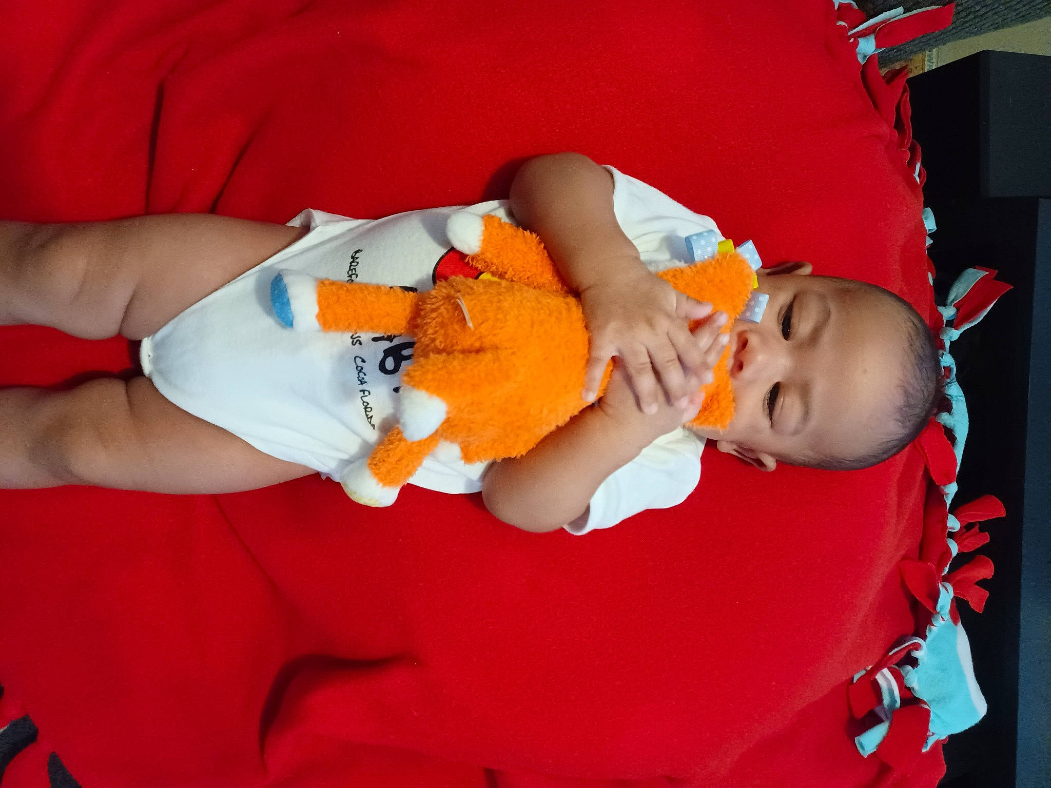 Jayceon is registered to the contest to win money with this photo: abdomen, baby, baby_products, baby_toddler_clothing, child, comfort, elbow, event, finger, hand, hat, human_leg, knee, lap, orange, person, sleeve, thigh, toddler, trunk