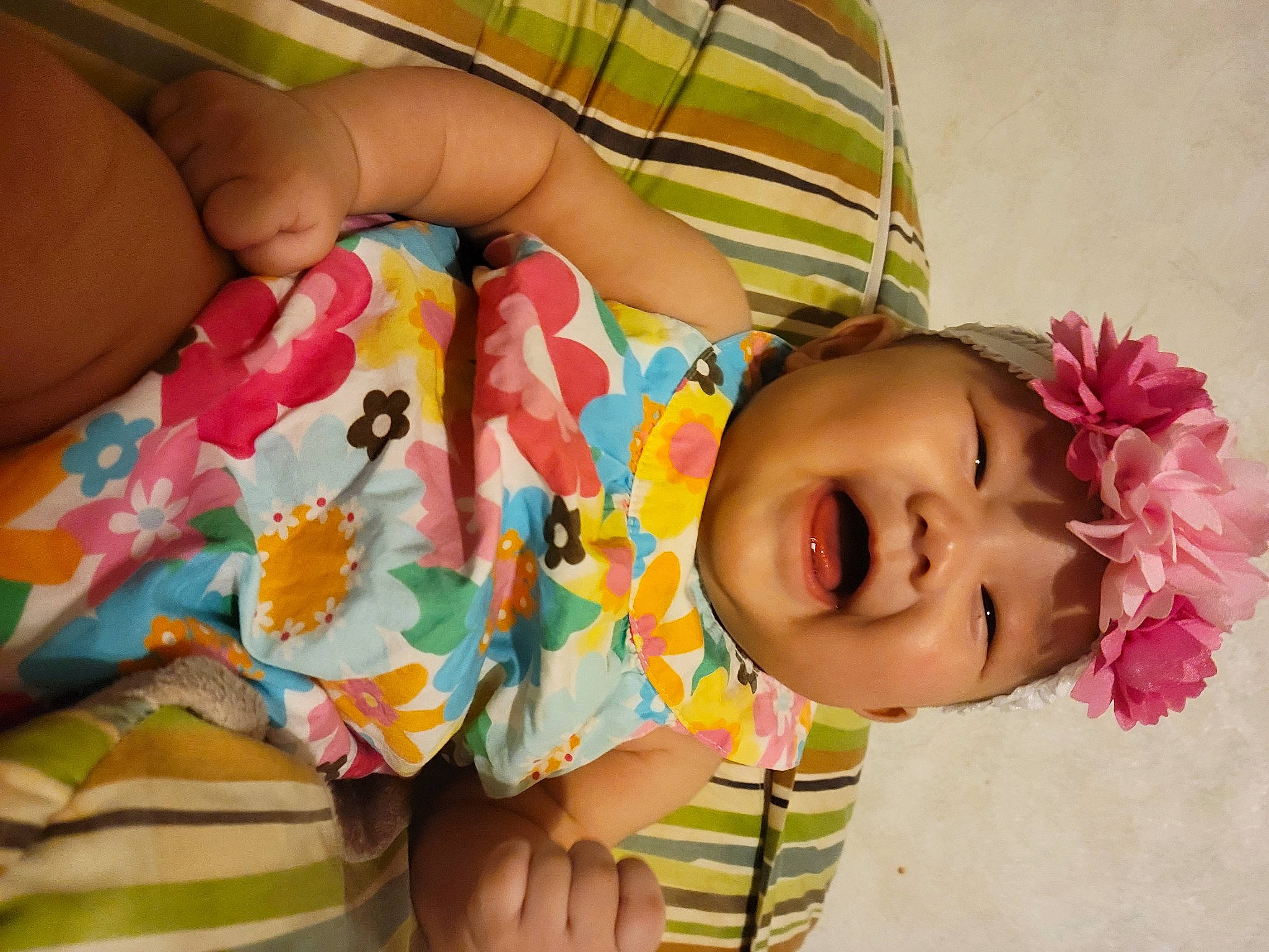 Analia is registered to the contest to win money with this photo: arm, baby, baby_toddler_clothing, cheek, dress, finger, hand, happy, headwear, human_body, iris, lip, mouth, nose, person, pink, product, skin, sleeve, smile