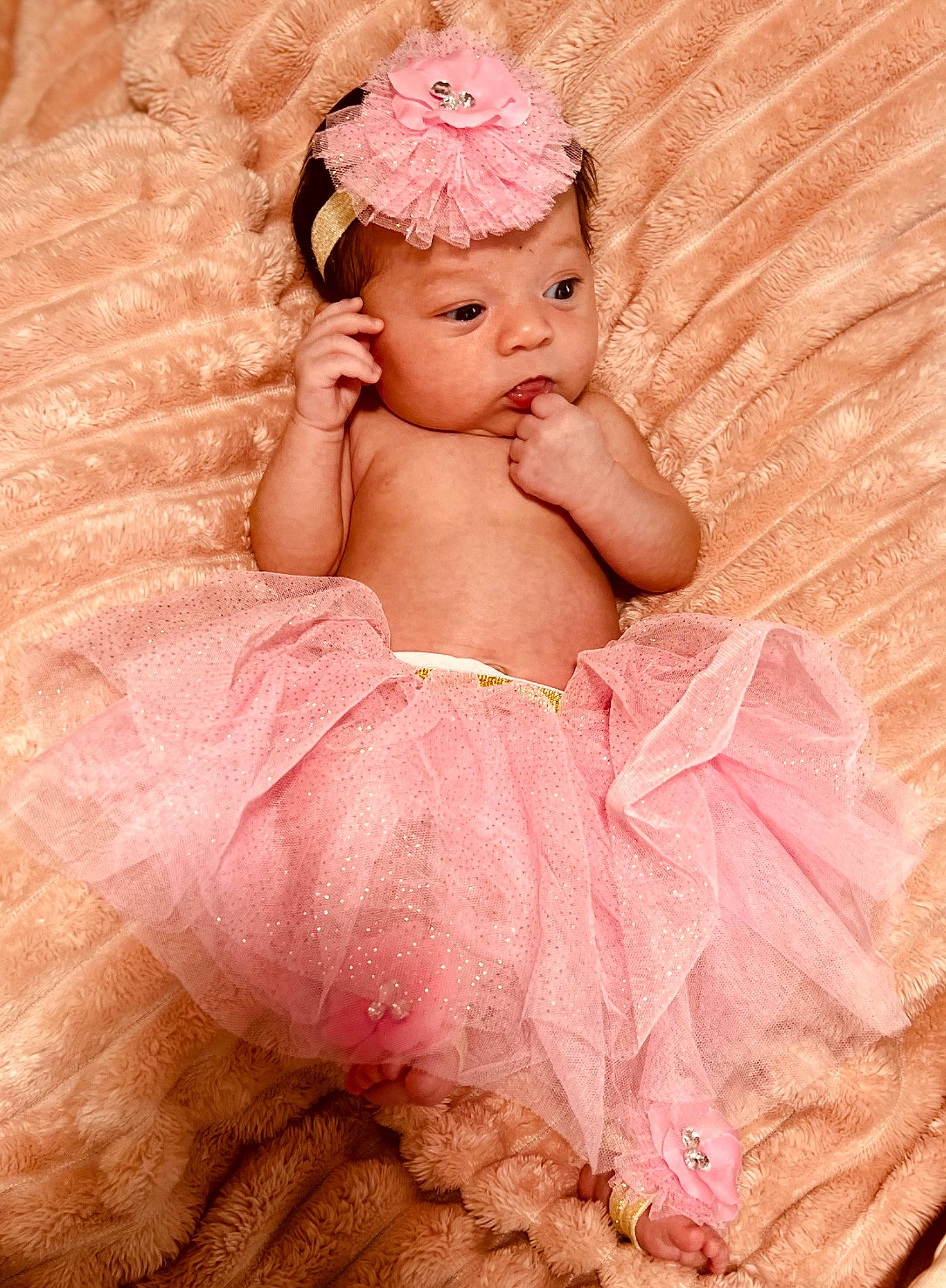 Kamiyah is registered to the contest to win money with this photo: abdomen, baby, baby_toddler_clothing, bridal_accessory, cheek, dress, embellishment, face, fashion_accessory, head, headgear, headpiece, headwear, lip, magenta, peach, person, pink, ruffle, skin