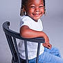 A'Layah joined the competition — help win amazing prizes! child, smiling, braids, white_bows, white_shirt, blue_jeans, black_chair, sitting, studio, portrait, happy, cute, fashion, young, person, casual, hair_accessories, indoor, childhood, joyful