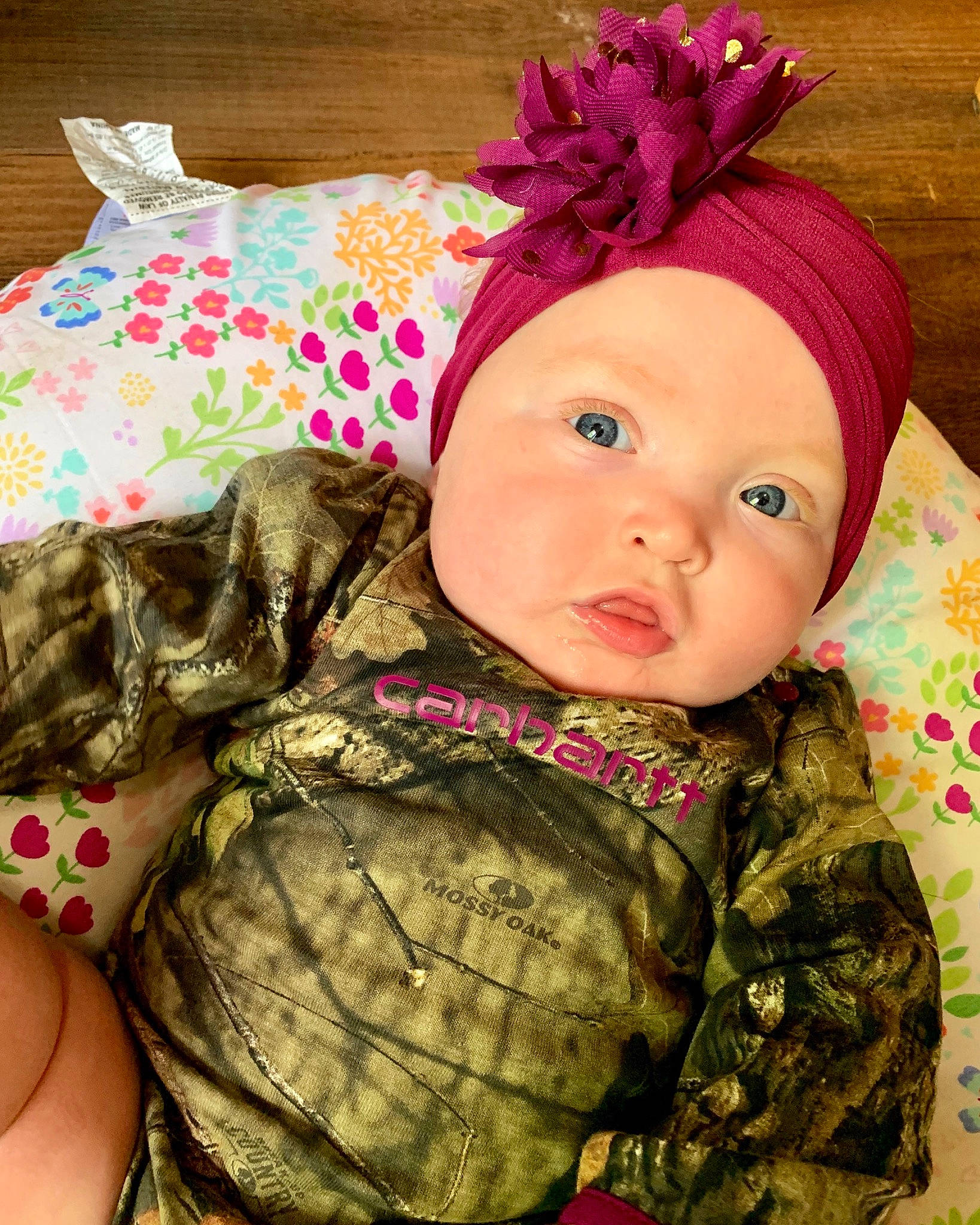 Ainsleigh is registered to the contest to win money with this photo: baby, baby_toddler_clothing, cheek, child, design, hair_accessory, head, headband, headgear, pattern, person, pink, plant, play, purple, textile, toddler, toy