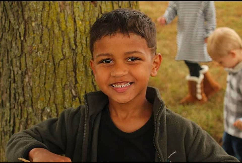 Jahlil is registered to the contest to win money with this photo: blurred, child, chin, event, flash_photography, fun, grass, hairstyle, happy, joy, leisure, people_in_nature, person, plant, shirt, shorts, sitting, smile, soil, standing