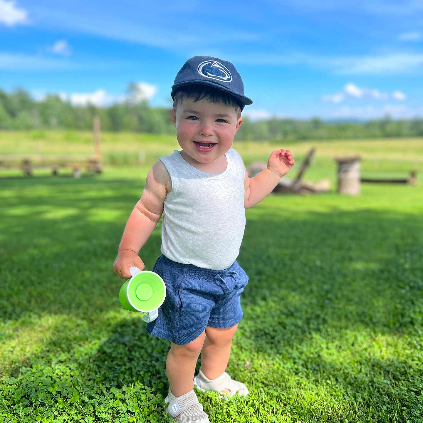 Brooks is registered to the contest to win money with this photo: baby, baseballcap, cap, clothing, face, field, grass, green, hat, head, nature, outdoors, pants, park, person, photography, plant, portrait, shorts, summer