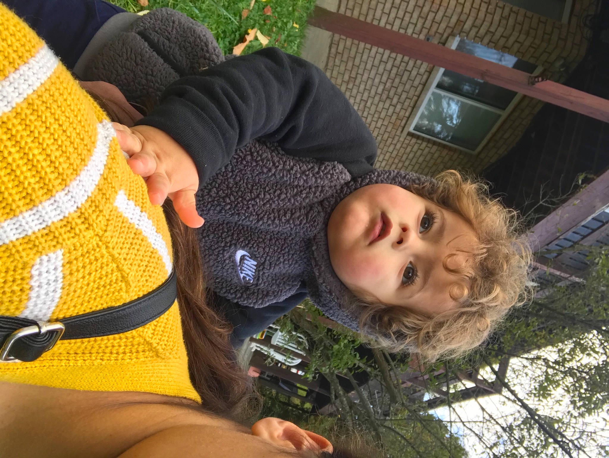 Greyson is registered to the contest to win money with this photo: beauty, child, cool, facial_expression, fun, grass, hairstyle, happy, human, human_leg, leaf, leisure, person, plant, sitting, spring, sunlight, toddler, tree, woolen