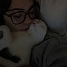 person, cat, glasses, sleeping, cuddle, blanket, indoor, cozy, affection, warmth, closeup, face, pet, comfort, resting, casual_clothing, human, animal, relaxation, bond