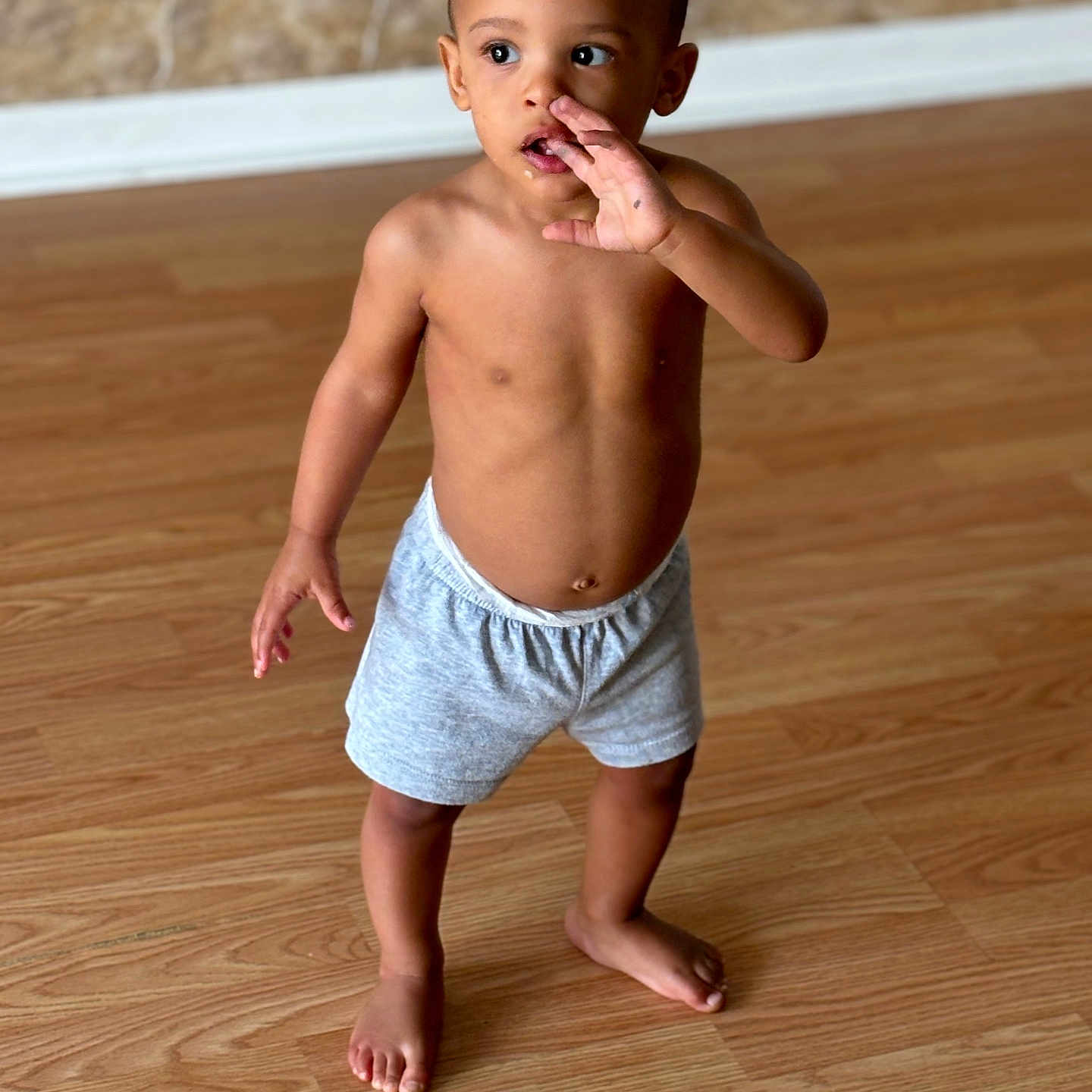 Kymani is registered to the contest to win money with this photo: baby, back, barefoot, bodypart, clothing, diaper, face, finger, hand, happy, hardwood, head, pants, person, photography, portrait, shorts, smile, swimmingtrunks, wood
