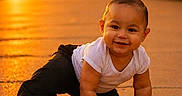 Armonii is registered to the contest to win money with this photo: baby, black_pants, child, crawling, cute, golden_hour, happy, infant, outdoor, pavement, portrait, red_shoes, smiling, sunlight, sunset, train, train_tracks, warm_light, white_shirt, young_child
