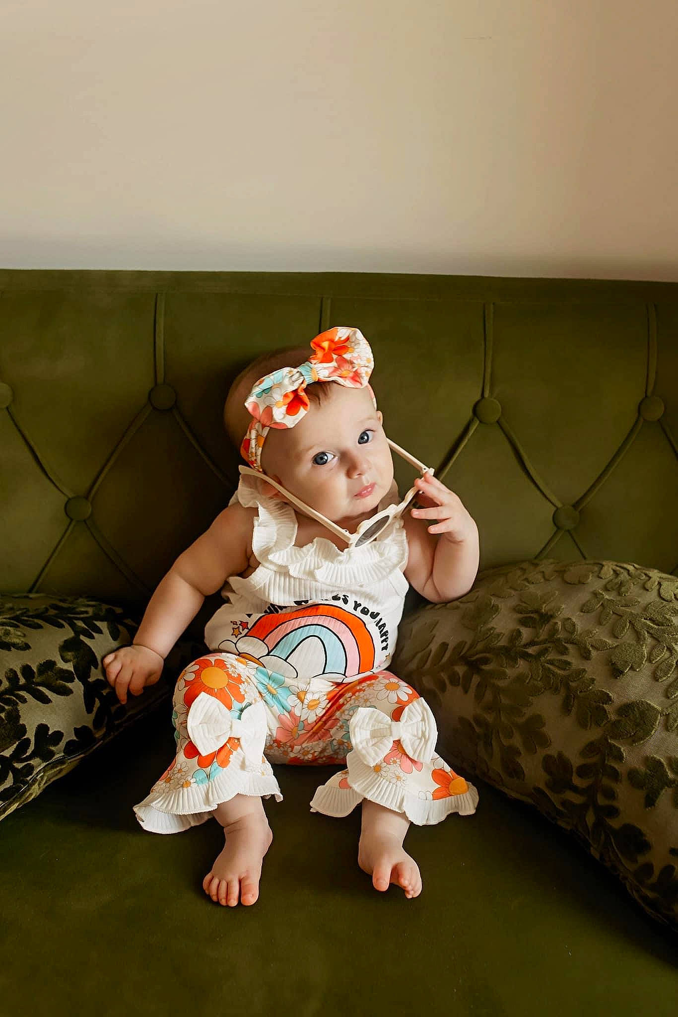Hadley is registered to the contest to win money with this photo: baby, baby_toddler_clothing, barefoot, child, comfort, couch, flash_photography, flooring, foot, fun, grass, happy, hat, headwear, human_leg, leg, pattern, person, sitting, sleeve