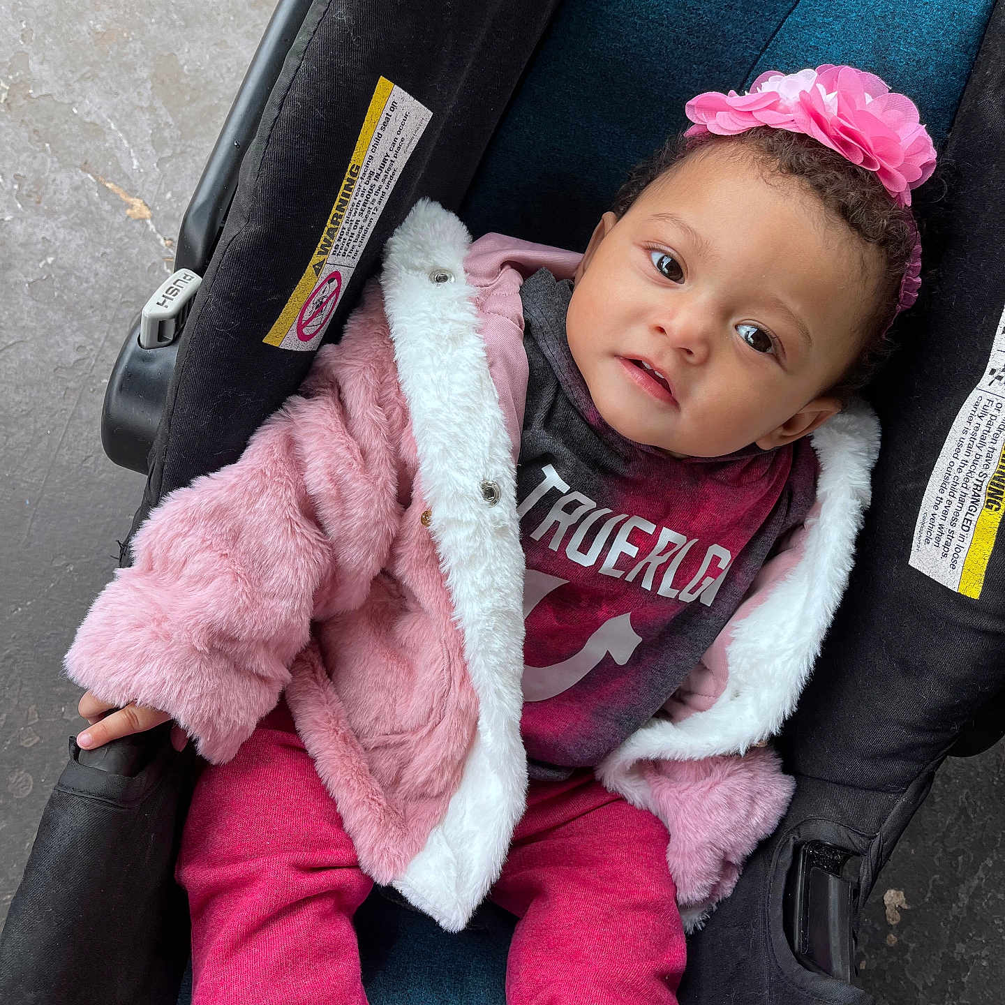Imelda is registered to the contest to win money with this photo: baby, car, car_interior, carseat, clothing, coat, face, footwear, hat, head, jacket, knitwear, pants, person, photography, portrait, shoe, sweater, transportation, vehicle
