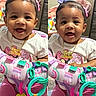 baby, child, smiling, pink_clothing, purple_bow, toy, colorful, indoor, face, happy, person, activity_center, infant, cute, playtime, portrait, babygirl, accessory, jewelry, split_image