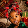 toddler, child, portrait, red_bow, plaid, holiday, christmas, gift, present, green_dress, face, smile, braids, earrings, cute, festive, indoor, decorations, black_hair, young_child