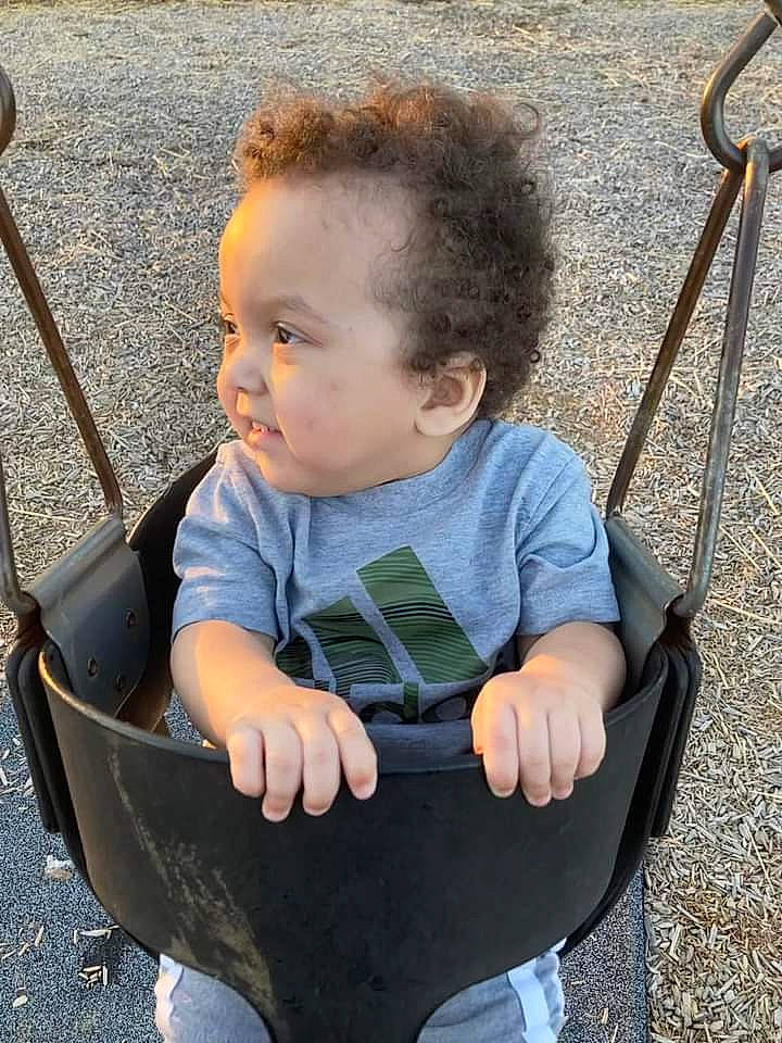 D'Quarius is registered to the contest to win money with this photo: baby, baby_carriage, baby_toddler_clothing, cheek, child, city, eye, face, facial_expression, fun, grass, human_body, human_settlement, leisure, person, plant, playground, skin, swing, toddler