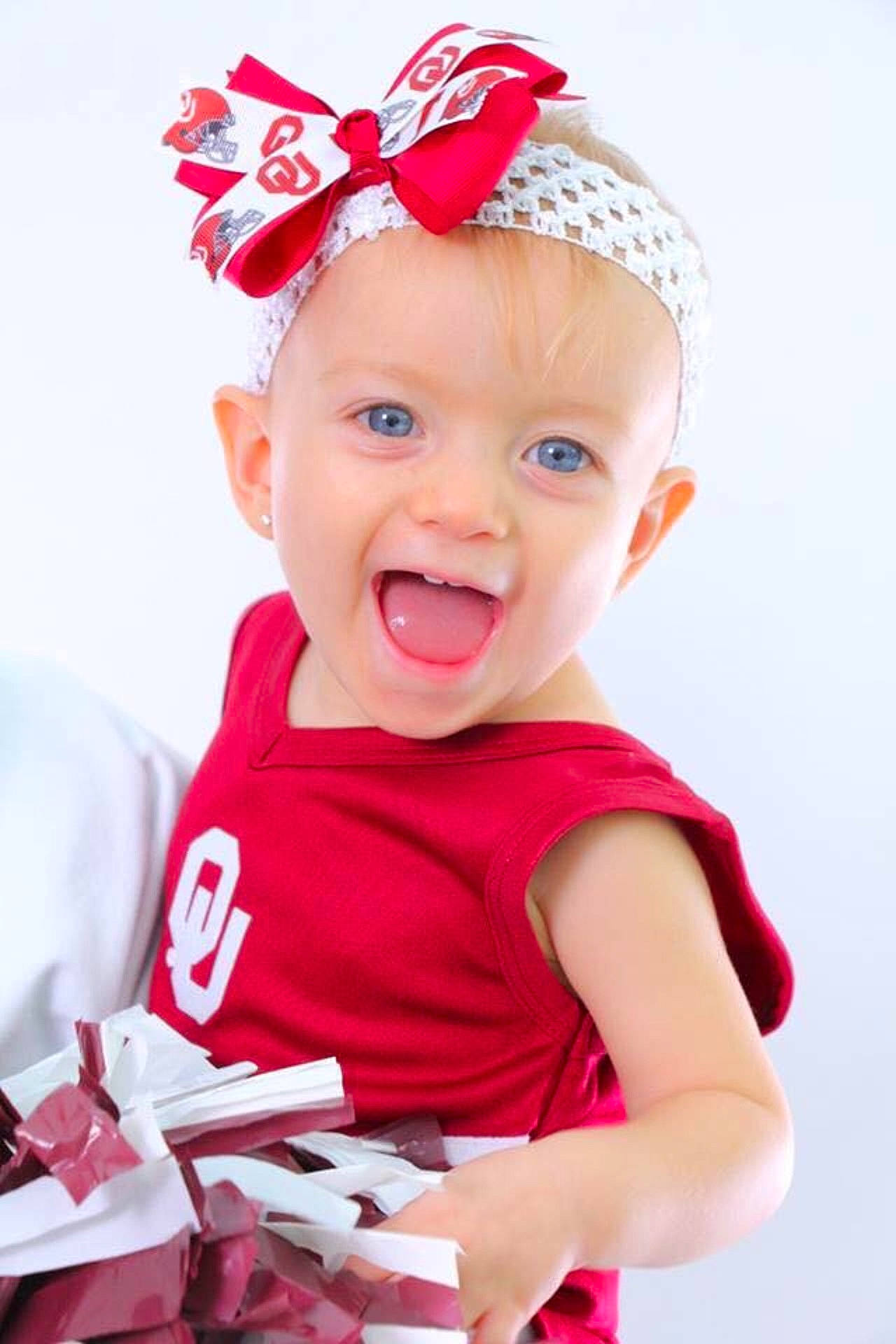 Trinity is registered to the contest to win money with this photo: cap, child, fashion_accessory, hair_accessory, headband, headgear, infant, party_hat, person, product, smile, toddler
