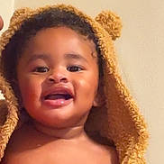 Montoya is registered to the contest to win money with this photo: toddler, child, smiling, happy, face, hooded_towel, bath_time, cute, baby, indoor, portrait, skin, expression, fuzzy, warm, person, young_child, headwear, bare_chest, cozy