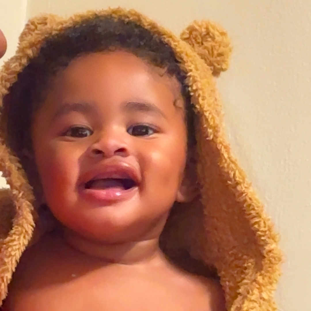 Montoya is registered to the contest to win money with this photo: toddler, child, smiling, happy, face, hooded_towel, bath_time, cute, baby, indoor, portrait, skin, expression, fuzzy, warm, person, young_child, headwear, bare_chest, cozy