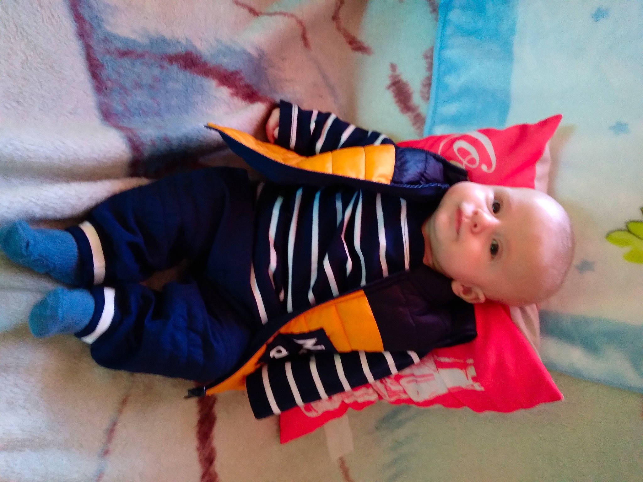 Owen participe au concours pour gagner de l'argent avec cette photo : baby, baby_products, baby_toddler_clothing, carmine, child, comfort, fun, happy, hat, linens, orange, pattern, person, room, sitting, sleeve, smile, sock, textile, toddler